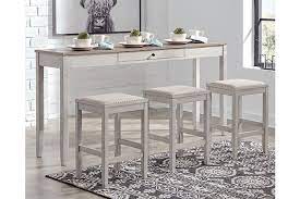 Complete your yard setup with outdoor accent tables. Skempton Counter Height Dining Table And Bar Stools Set Of 3 Ashley Furniture Homestore