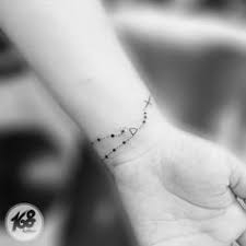 Popular are the tattoos with the beads winded several times around the wrist with a cross falling down the hand or a rosary scattered all over the. Small Rosary Tattoo On Wrist Rosary Tattoo Wrist Rosary Tattoo Rosary Foot Tattoos