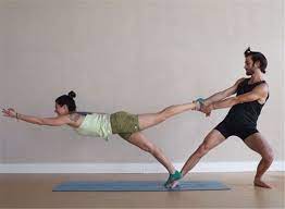 Keep your spine long, and your skull on the floor without arching your neck or lower back. Amazing Partner Yoga Poses To Strength Trust And Intimacy Couple Yoga Couple Yoga Poses Partner Couples Yoga Poses Partner Yoga Poses Two People Yoga Poses