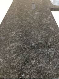Using a medium grey granite, to match the appliances and stove hood, brings uniformity throughout the kitchen. Steel Gray Granite Countertop Grey Granite Countertops Granite Countertops Kitchen And Bath Remodeling