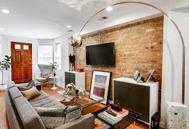 The Exposed Brick Wall Creates A Nice Feature For The Living Room Of This 2 Bedroom Apa Exposed Brick Wall Living Room Brick Wall Living Room Brick Living Room