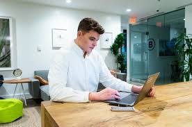 working on laptop at the office desk ...