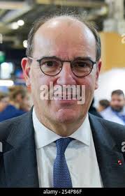 Former Prime Minister of France Jean-Pierre Raffarin, center, receives an  honorary doctorate from the University of Sherbrooke rector Bruno-Marie  Bechard, as Quebec Premier Jean Charest, left, looks on, Thursday, Sept. 7,  2006