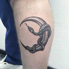 Dot Work Style Tattoo Of A Snake Wrapped Around The Moon Inked On The Left Calf Arm Tattoos Snake Tattoos Leg Tattoos