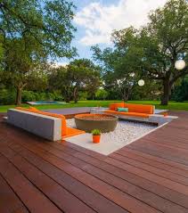 The wood deck fire pit comes with a porcelain grate for cooking. 25 Welcoming And Stylish Sunken Patios And Decks Digsdigs