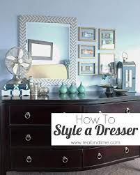 A couple of weeks ago i shared our master bedroom refresh style board and today is the full reveal! How To Style A Long Low Dresser Teal And Lime Dresser Decor Bedroom Style A Dresser How To Style A Dresser
