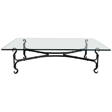 Impressive, gothic influenced, artisan blacksmith made, coffee table circa 1940s features a handwrought, iron x base with 3/4 inch thick glass top. Large Gothic Artisan Handwrought Iron And Glass Coffee Table For Sale At 1stdibs