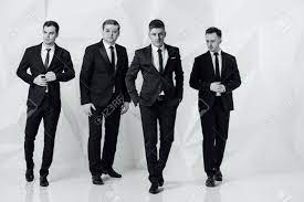 Group Of Four Men In Suits White Background Stock Photo Picture And Royalty Free Image Image 94516649