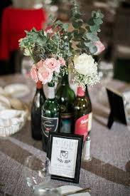 Simple Wedding Centerpiece Idea Wine Bottle Centerpiece With Pink White Roses And Simple Wedding Centerpieces Wine Bottle Centerpieces Wedding Centerpieces
