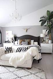 This lovely primary bedroom has a black platform bed with a large cushioned and tufted headboard to stand out against the bright white walls and white shed ceiling. Pin By Ebru Ince On Art Inspiration Master Bedrooms Decor Bedroom Interior White Bedroom Furniture