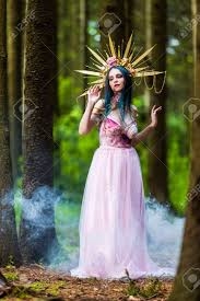 Sexy And Sensual Crowned Forest Nymph With Flowery Golden Crown Posing In Smoky Summer Forest Against High Trees Vertical Image Composition Stock Photo Picture And Royalty Free Image Image 152402432
