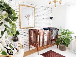 Large nursery room with white stylish walls, an interesting rug and a hardwood flooring. 9 Tips For Creating Gorgeous Gender Neutral Nurseries