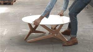 A rectangular white foldout top of wood rotates 90 degrees. Watch This Coffee Table Convert To A Dining Table In One Move Coffee Table To Dining Table Transforming Furniture Convertible Coffee Table
