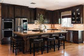 Here, the original varnish was stripped off to create a rustic look, and a clear stain was used to seal it. Traditional Mediterranean Custom Kitchen Cabinets In Paso Robles California Sligh Cabinets Inc