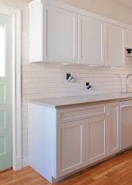 Caulk where the backsplash meets the upper cabinets. Tile Partway Up The Wall Around Cabinets Setting The Backsplash Via Bloglovin Com Kitchen Cabinet Molding Kitchen Tiles Backsplash Kitchen Cabinets Trim