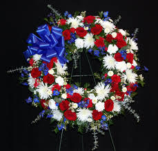 Creamy magnolia, hydrangea and gardenia blossoms, and spikes of white iris and gladiolus, can become part of a red, white and blue display, too. Red White And Blue Wreath By York Flowers