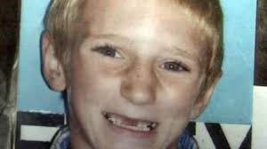 Boy dies after running in front of pickup