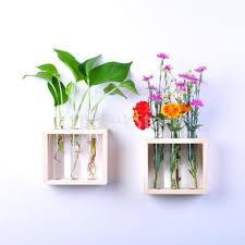 The kaki flower vase is a translucent sheet with a bubble of water that creates the illusion of levitating flowers. Hanging Flower Vase Bottles In Wood Stand