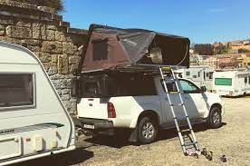 our setup in early 2018 in porto portugal where we had a caravan trailer and ikamper skycamp roof top tent mounted on toyota hilux