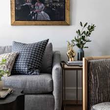 The slate blue rug and pillows below are a just a few shades off from the gray of the couch and the wall hanging 20 Ways To Decorate With Gray In The Living Room