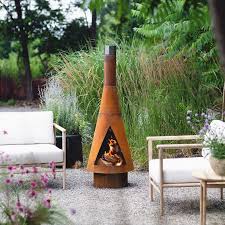 Since a chiminea is more closed off, you'll gather more closely around it. 10 Best Chiminea Fire Pits For Your Backyard Clay Steel And More Hgtv