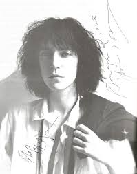 Patti Smith with Jimmy Iovine, who produced the album "Easter" in 1978.  They are looking at a Lynn Goldsmith shot of Patti and Jimmy recording the  song "Because the Night".