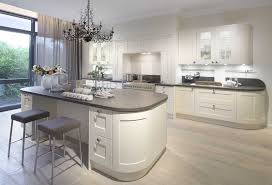Bright kitchen with a long curved center island proving a bar for four, lighted by three pendant lights. Curved Kitchen Island With Breakfast Bar Curved Kitchen Classic Kitchen Design Luxury Kitchen Design