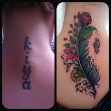 Brilliantly covered cross tattoo behind the neck. Back Piece Name Cover Up With Feather And Flowers Cover Tattoo Cover Up Tattoos For Women Cover Up Tattoos