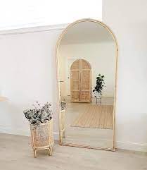 The rustic frame and unique design will make this the centerpiece of any room. Lola Arched Mirror Koko Collective