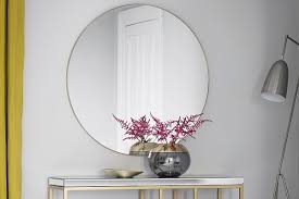 Lovingly crafted metal geometric spokes overlap over a framed accent mirror. How To Choose The Best Mirror For Your Space Sofa Com