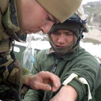U.S. Navy PETTY Officer 3rd Class Will Hurley, a Hospital Corpsman with  Weapons Company, 3rd Battalion, 3rd Marine Regiment, gives U.S. Marine  Corps Lance CPL. Dusty Stapleton, a rifleman with 3rd Battalion,