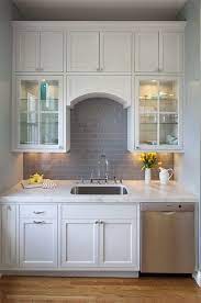 Vineyard kitchen backsplash mural idea this custom kitchen alcove features our vineyard tile mural with pot filler, wolf range and 4x4 gold travertine tuscany arch and see more install pics. White Kitchen With Glossy Walls Gray Subway Tile Marble Countertops Lighted Glass Cabin Gray Subway Tile Backsplash Grey Subway Tiles Backsplash Tile Design
