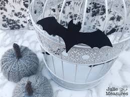 Add some color and whimsy to your halloween decor with these colorful cuties made with felt, a branch foraged from your backyard and other simple craft accessories. Diy Bat Decor Halloween Bat Cage Julie Measures