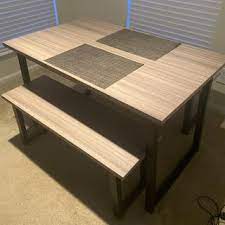 Includes table and 2 benches dining table and benches with sled legs and a black finish Waylowe Dining Table And Benches Set Of 3 Ashley Furniture Homestore