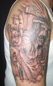 Here, the artist takes a simple design and uses an interesting technique and application to create this black and gray tattoo. Best Jesus Tattoos For Men
