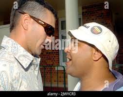 An Aboriginal protestor (r) argues with a man outside the Goondiwindi  Magistrates court where David Hillary Tomkins, 44, and his son Clint  William Tomkins, 23, appeared and were granted bail to reappear