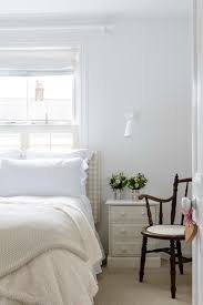 This bedroom has a coastal feeling, with blue bedding and white furniture. White Vs Cream Which Neutral Paint Color Is Right For You