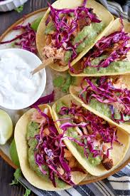 Salomn fish tacos w corn tortials. Salmon Tacos With Tomatillo Guacamole And Red Cabbage Slaw Foodal