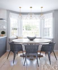 Modern Coastal Style Oval Dining Table In Kitchen With Bay Window And Modern Lighting Dining Room Remodel Dining Table In Kitchen Home Remodeling