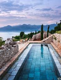 15 Beautifully Designed Swimming Pools Architectural Digest Stone Pool Backyard Pool Swimming Pool Designs