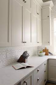White and gold kitchen features white cabinets adorned with long gold pulls paired with silestone countertops and backsplash that resemble white marble. Best Home Decor Paint Colors Edgecomb Gray The Turquoise Home