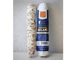 On a black wooden background. Farmers To You Black Pepper Salami