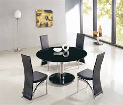 Round tables encourage conversation and offer more clearance space surrounding them — great for smaller or irregularly shaped spaces. Maxi Round Glass Dining Table And Chairs Glass Tables