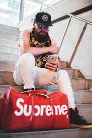 Pics images photos louis vuitton wallpaper hd. Hd Wallpaper Man Sitting On Stairs With Red Louis Vuitton X Supreme Leather Duffel Bag Wallpaper Flare