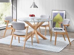 The dining table has a glass top with timber legs. Bella Round Dining Sets Glass Top On Sale