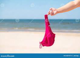 Close Up of Young Woman Taking Off Her Bra at Nude Beach. Concept of  Sunbathing Naked on the Sandy Ocean Beach Stock Image - Image of bare,  beautiful: 215019771