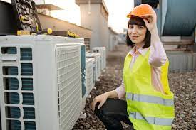 Technician checking duct work in a crawl space