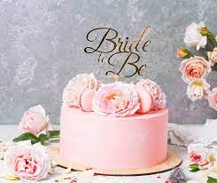 Pink cake with flowers on top. Pink Wedding Cake With Roses And Macaroons With Topper Bride To Be Top View Flat Lay Stock Photo Picture And Royalty Free Image Image 81391555