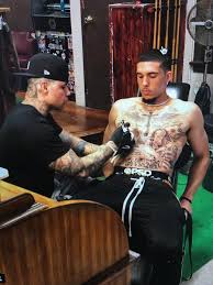 The high schooler of the ball family, lamelo, got inked up this week deciding to go with this massive tattoo artist herchell carrasco tells us the youngest ball brother wanted wings and his jersey number. Li Angelo Ball Chest Tattoo Family Photo Outfits Winter Fall Family Photo Outfits Family Photo Outfits