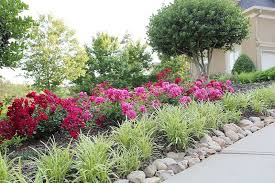 I Want To Take Wheelbarrows Full Of River Rock And Line Our Driveway Then Plant Flowers Shrubbery Al Driveway Landscaping Flower Bed Designs Driveway Entrance
